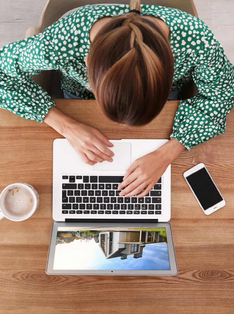 Woman shopping for a house on her laptop